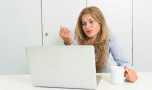 young woman with laptop and cup of tea think of anything else